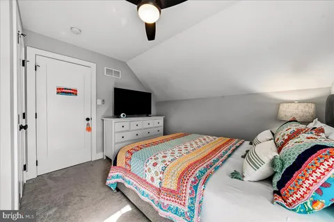 a living room with furniture and painting on the wall