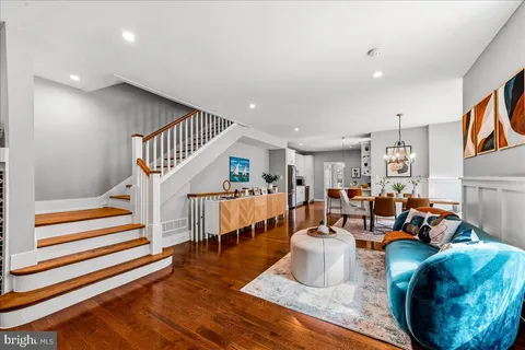 a living room with fireplace furniture and a wooden floor