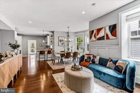 a living room with furniture dining table and a large window