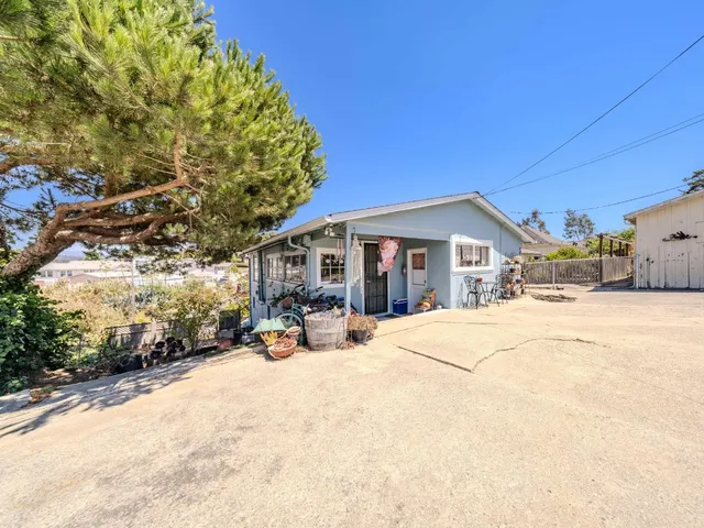 a view of a house with snow in front of house