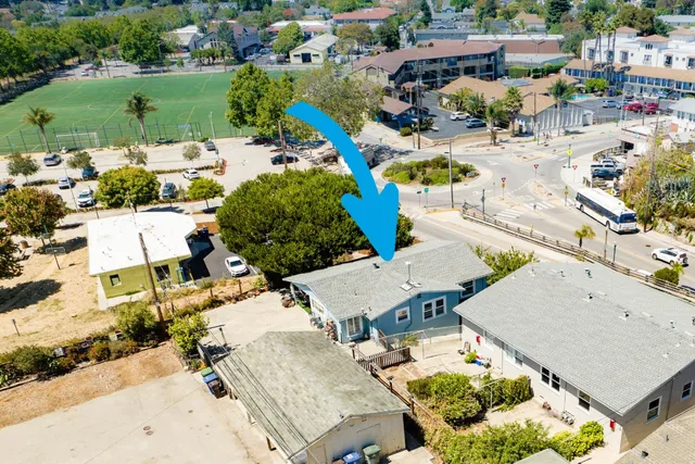 an aerial view of a house with a swimming pool and outdoor space