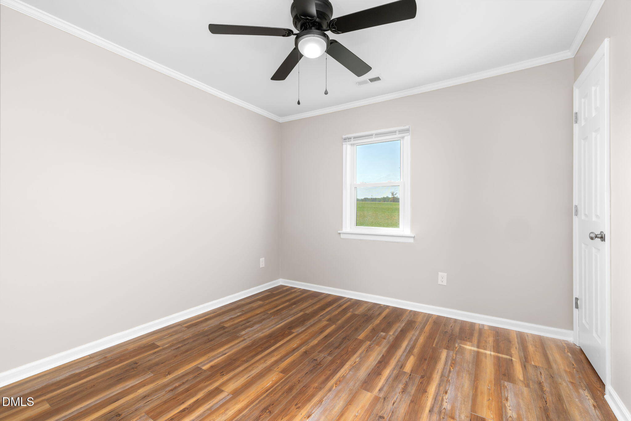 426 Rooker Dairy Road Norlina, NC 27563 - Photo 18 of 33 an empty room with a window and a ceiling fan
