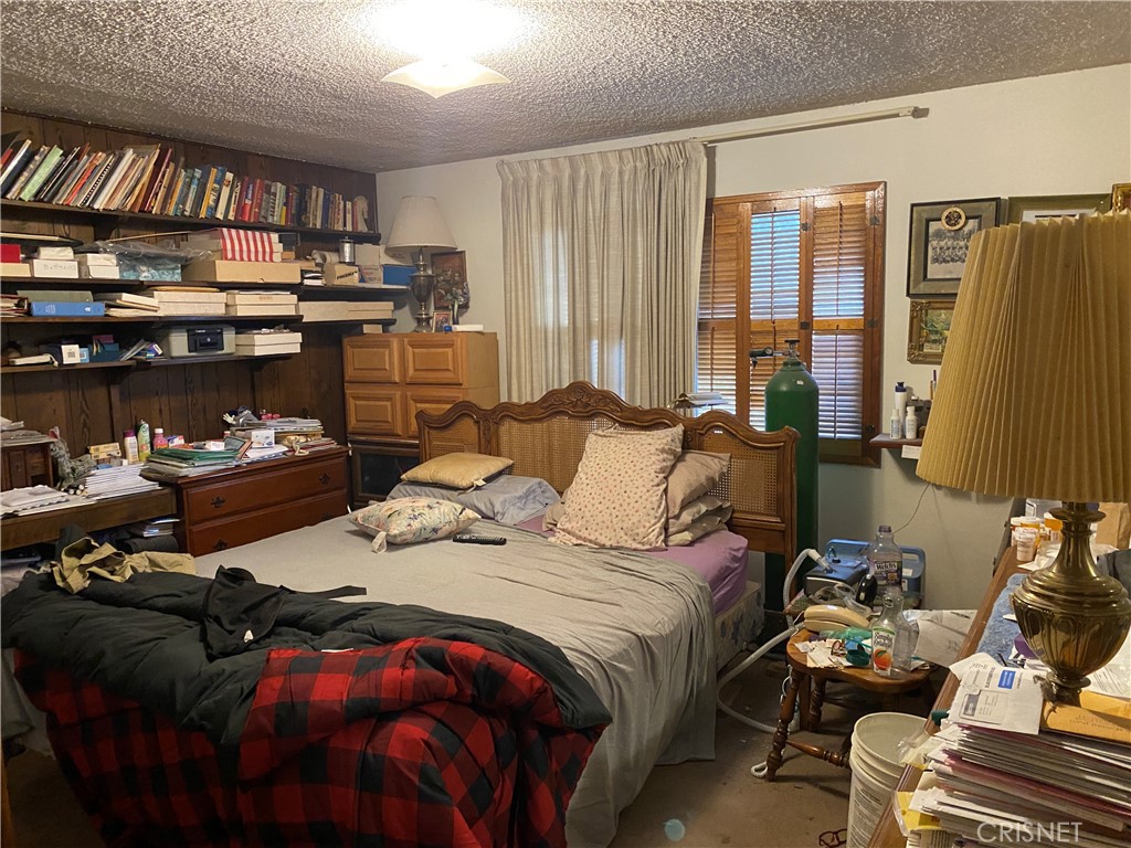 6512 Franrivers Avenue West Hills, CA 91307 - Photo 11 of 24 a bedroom with a bed and a book shelf