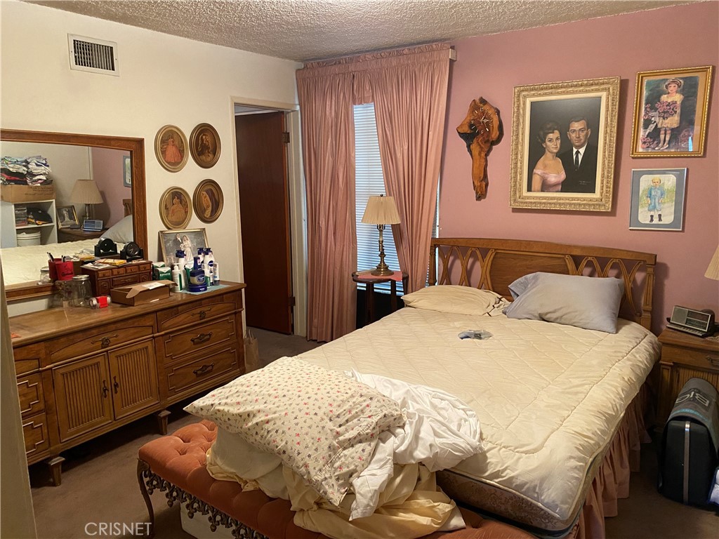 6512 Franrivers Avenue West Hills, CA 91307 - Photo 16 of 24 a spacious bedroom with a bed and a mirror
