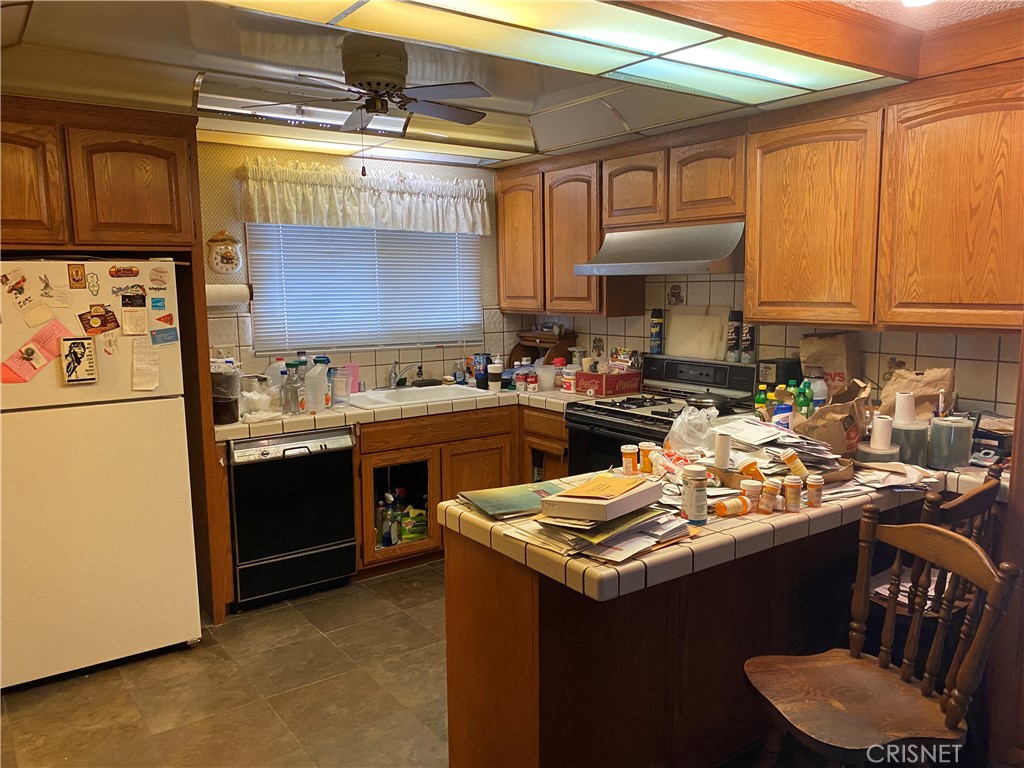 6512 Franrivers Avenue West Hills, CA 91307 - Photo 20 of 24 a kitchen with a sink stove and refrigerator