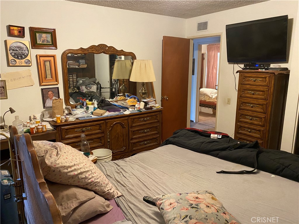 6512 Franrivers Avenue West Hills, CA 91307 - Photo 10 of 24 a bedroom with a bed and flat screen tv
