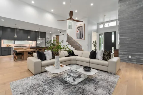 a living room with furniture and a chandelier
