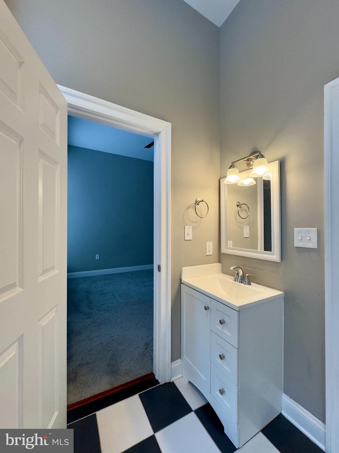 803 Cathedral Street, Unit 4 Baltimore, MD 21201 - Photo 11 of 12 a spacious bathroom with a double vanity sink and mirror