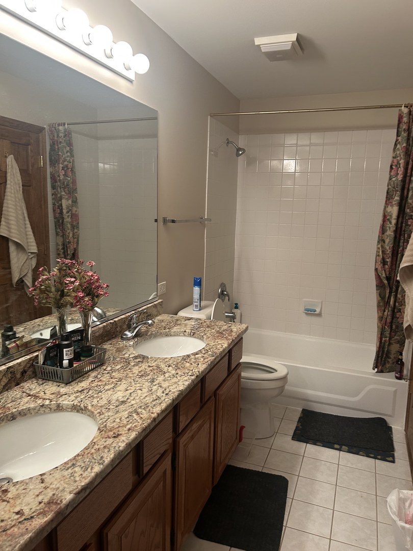 527 Springwood Lane Bolingbrook, IL 60440 - Photo 23 of 35 a bathroom with a granite countertop sink toilet and shower