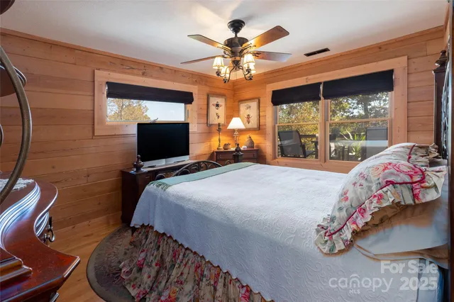 a bedroom with a bed and a chandelier