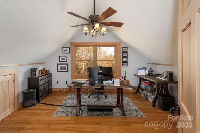 a living room with furniture a fireplace and a window
