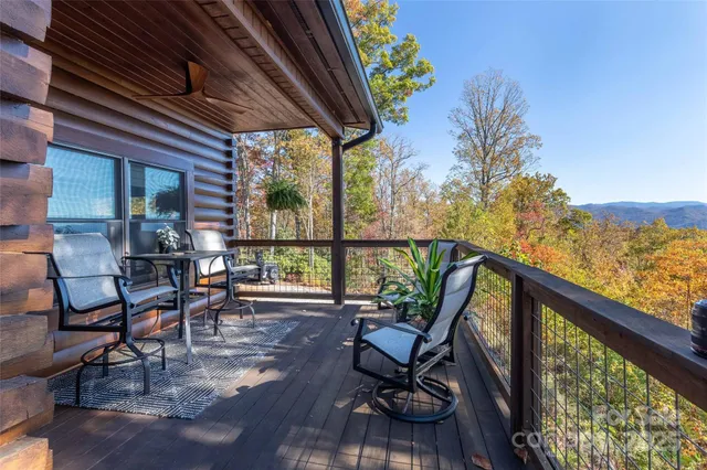 a view of balcony with chairs and wooden floor