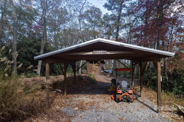 a view of backyard with small tub and wooden fence