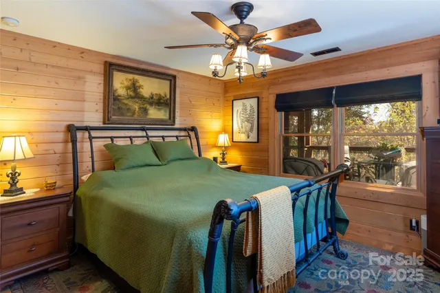 a bedroom with a large bed and a chandelier