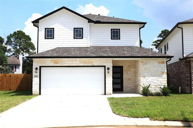 a view of a house with a yard and garage