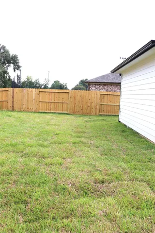 a view of a yard with a house in the background