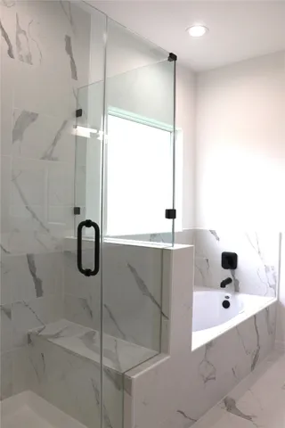 a bathroom with a tub and a shower