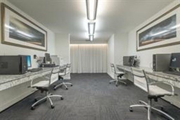 a view of a livingroom with workspace and a window