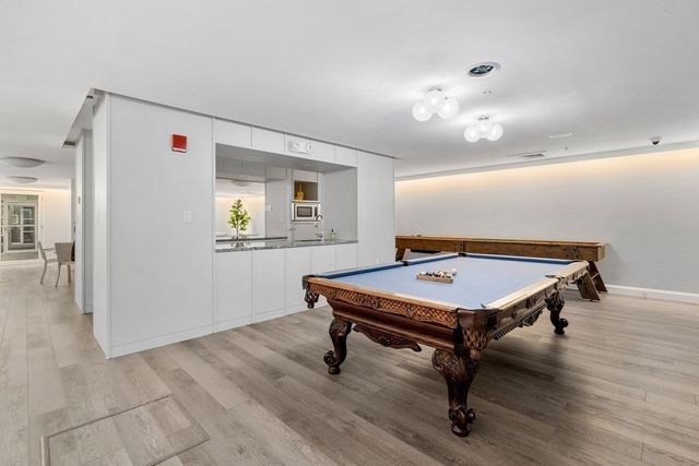 a room with pool table and windows