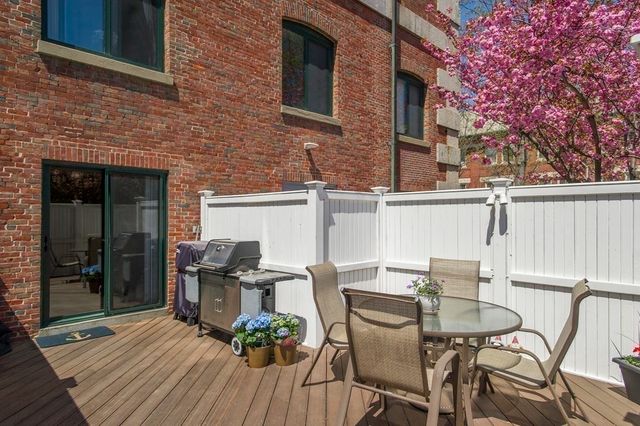 a view of a patio with table and chairs and potted plants