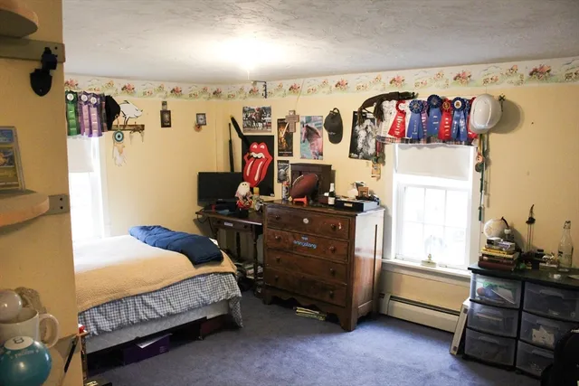 a bedroom with bed and a window