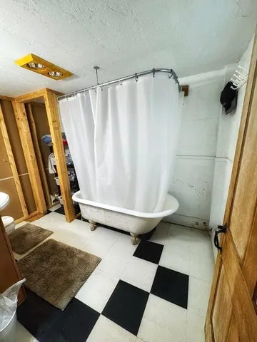 a bathroom with a sink toilet and mirror
