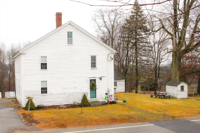 a front view of house with yard and garage