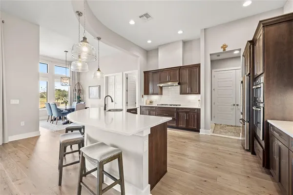 a dining room with furniture a clock and a large window