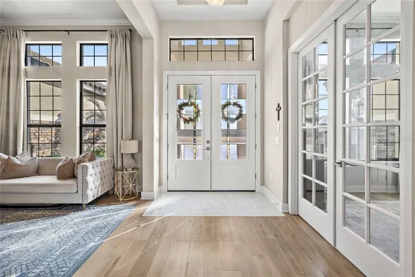 a kitchen with stainless steel appliances a dining table chairs refrigerator and microwave