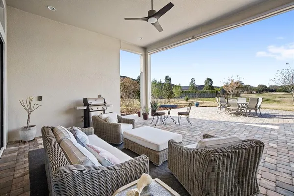 a view of a lake with table and chairs