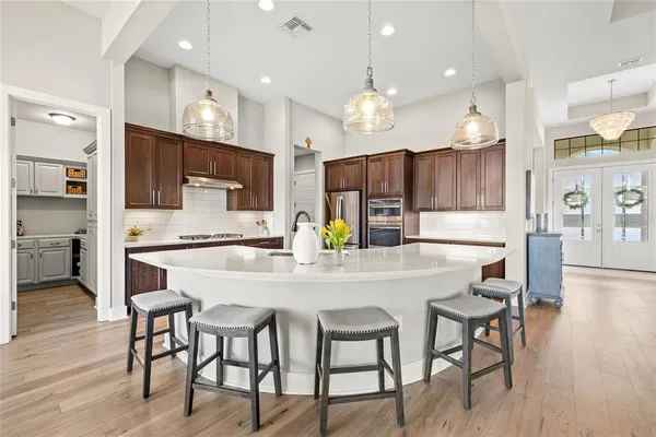 a large kitchen with kitchen island a large island in the center