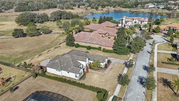 an aerial view of a house with a garden and swimming pool