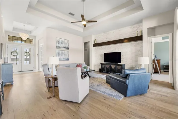 a living room with furniture and a floor to ceiling window