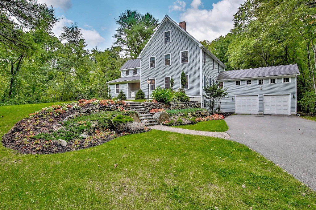 126 Taylor Road Stow, MA 01775 - Photo 1 of 16 a front view of a house with a garden