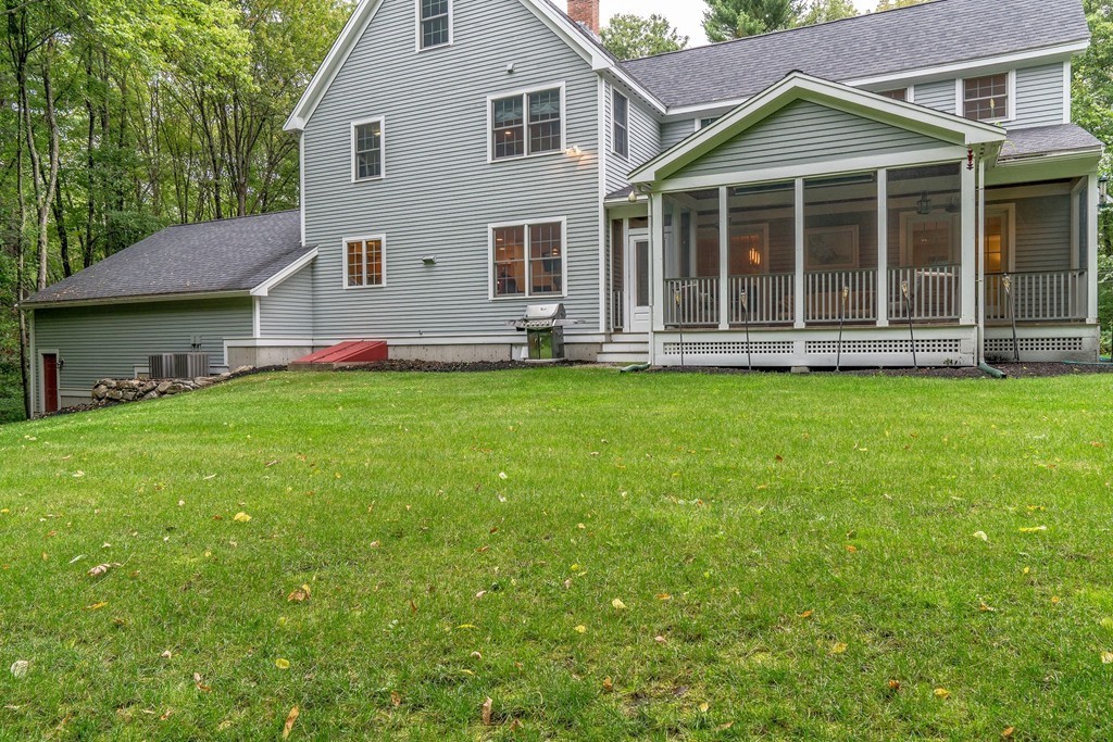 126 Taylor Road Stow, MA 01775 - Photo 16 of 16 a view of a house with a garden