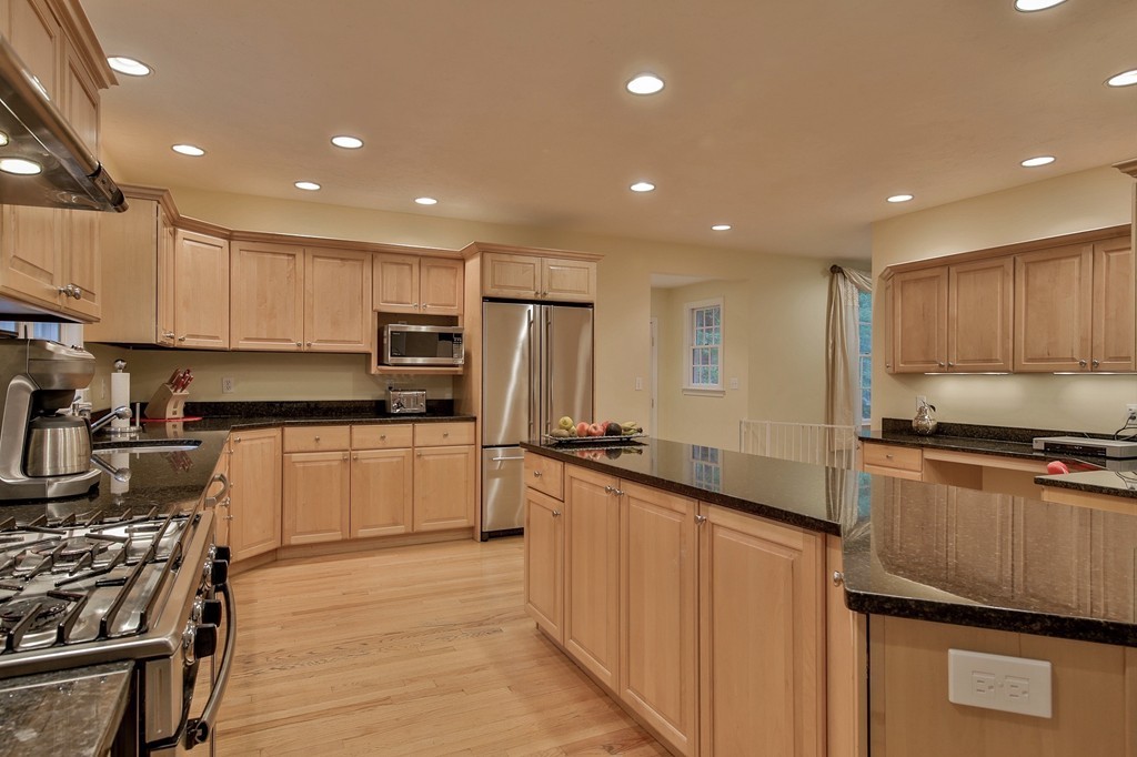 126 Taylor Road Stow, MA 01775 - Photo 3 of 16 a kitchen with stainless steel appliances a stove top oven a sink a refrigerator and white cabinets