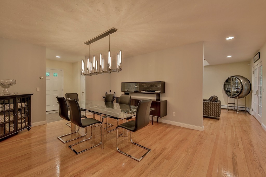 126 Taylor Road Stow, MA 01775 - Photo 5 of 16 a view of a dining room with furniture a chandelier and wooden floor