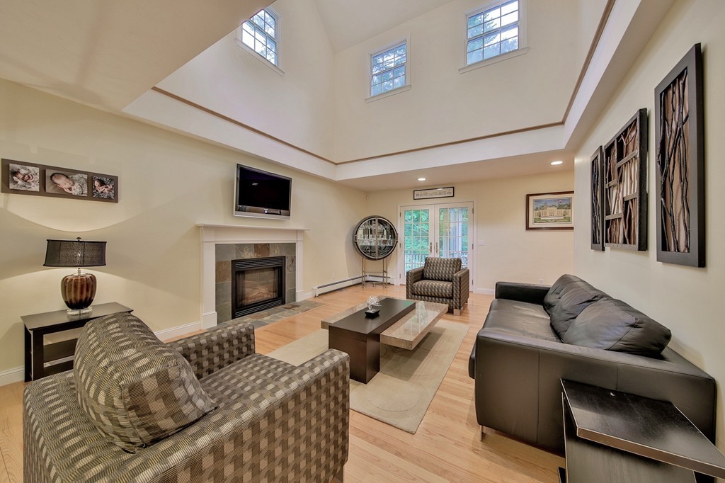 126 Taylor Road Stow, MA 01775 - Photo 7 of 16 a living room with furniture a fireplace and a flat screen tv