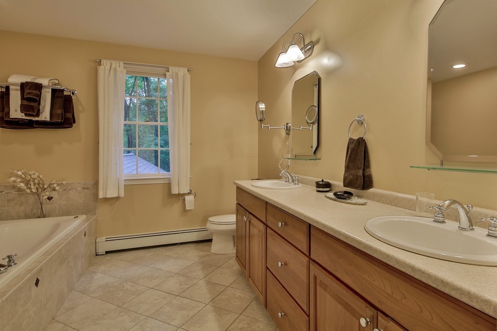 126 Taylor Road Stow, MA 01775 - Photo 10 of 16 a bathroom with a tub sink and mirror