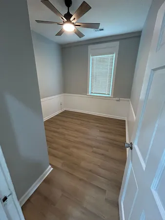 wooden floor in an empty room with a window