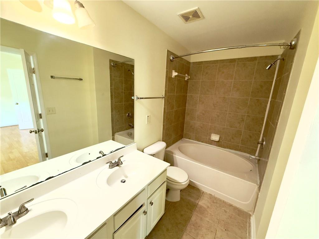 1035 Prestwyck Court Alpharetta, GA 30004 - Photo 15 of 21 a bathroom with a bathtub shower sink vanity and toilet