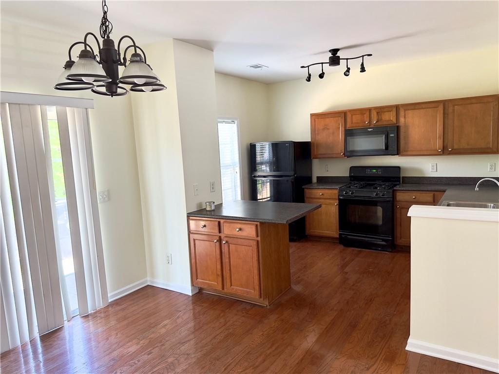 1035 Prestwyck Court Alpharetta, GA 30004 - Photo 9 of 21 a kitchen with granite countertop a refrigerator a stove top oven a sink and dishwasher