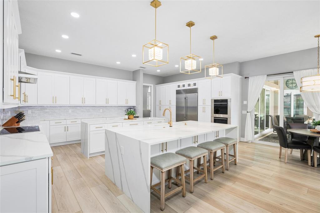 9810 Compass Point Way Tampa, FL 33615 - Photo 14 of 81 a large white kitchen with lots of counter space a sink appliances and dining table