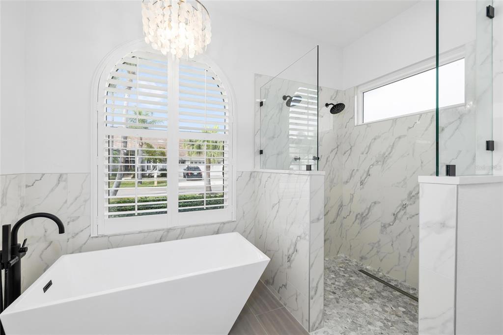 9810 Compass Point Way Tampa, FL 33615 - Photo 31 of 81 a bathroom with a bathtub and shower