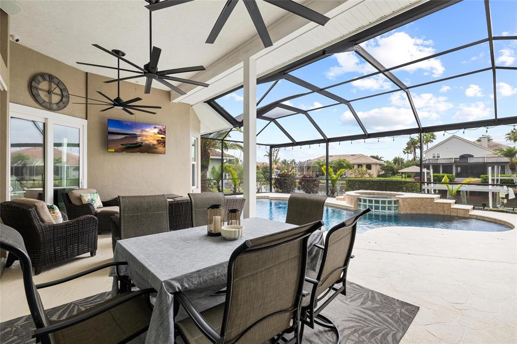 9810 Compass Point Way Tampa, FL 33615 - Photo 40 of 81 a dining room with furniture a chandelier and a rug
