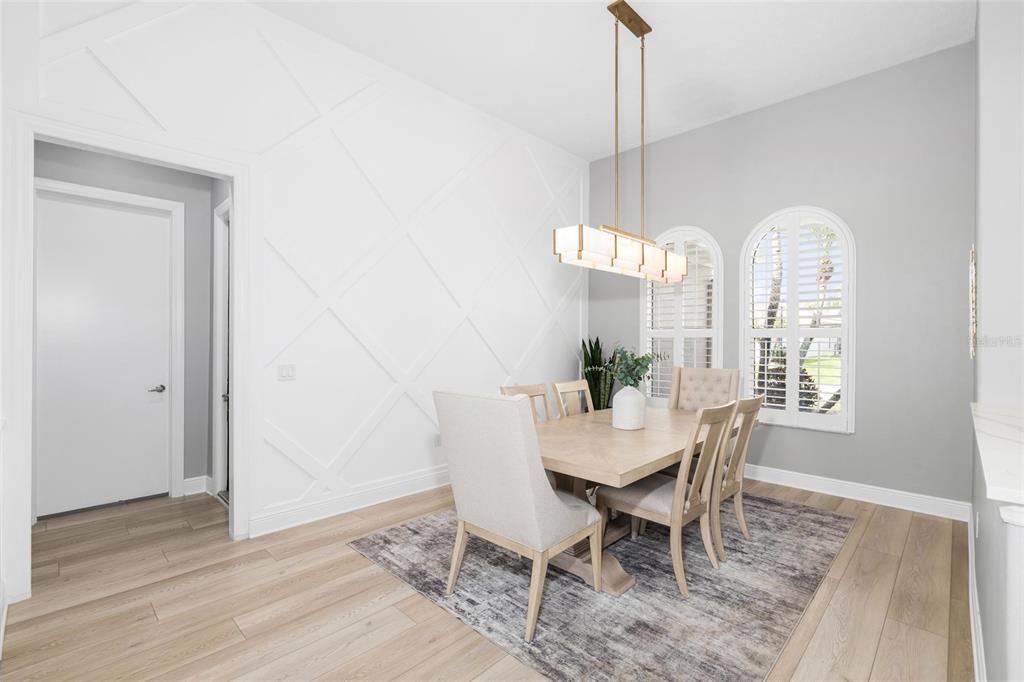 9810 Compass Point Way Tampa, FL 33615 - Photo 7 of 81 a dining room with furniture a chandelier and wooden floor