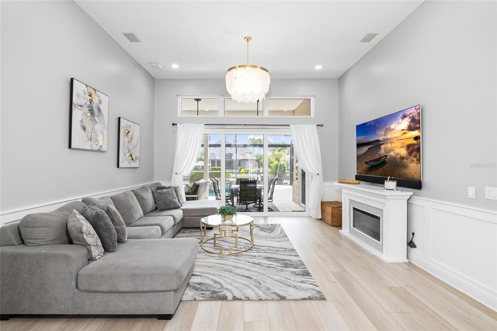 9810 Compass Point Way Tampa, FL 33615 - Photo 8 of 81 a living room with furniture a flat screen tv and a fireplace