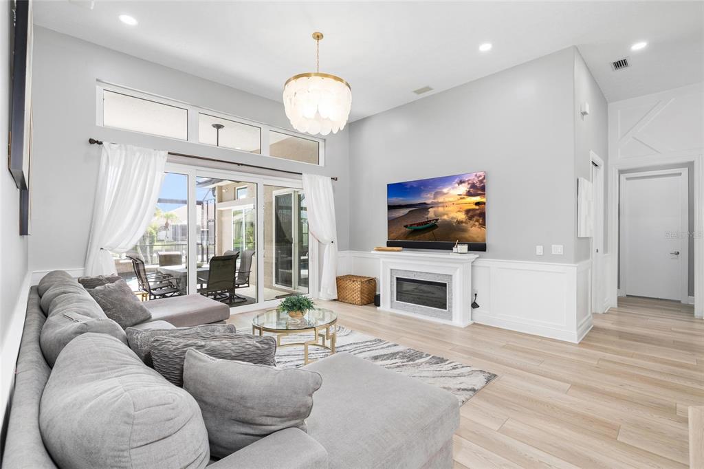 9810 Compass Point Way Tampa, FL 33615 - Photo 10 of 81 a living room with fireplace furniture and a flat screen tv