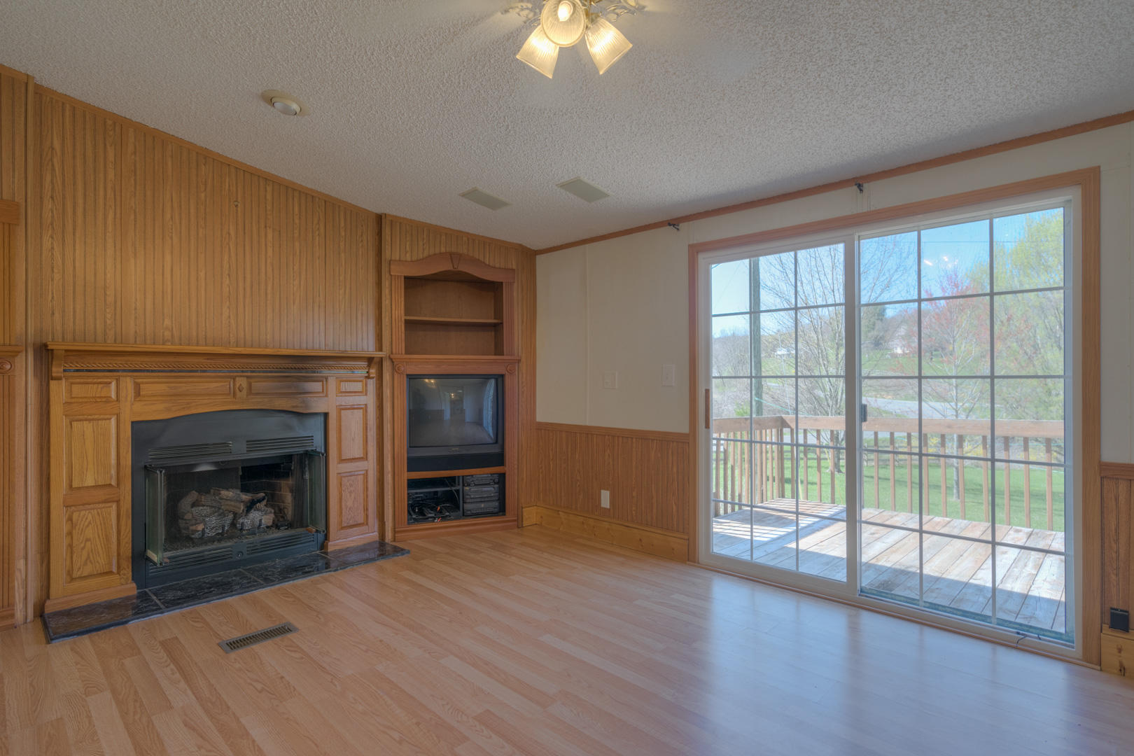385 Sam Reed Road Northwest Floyd, VA 24091 - Photo 22 of 33 a view of an empty room with wooden floor fireplace and a window
