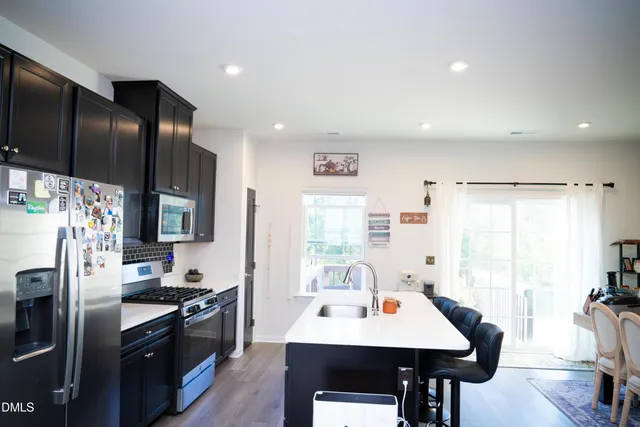 a dining room with furniture and wooden floor